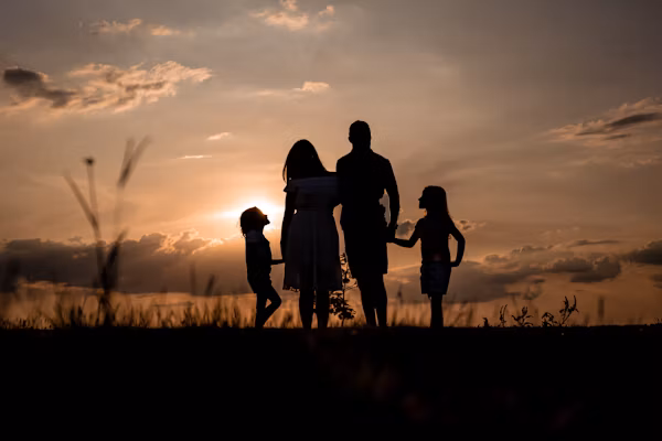 Family holding hands at the beach